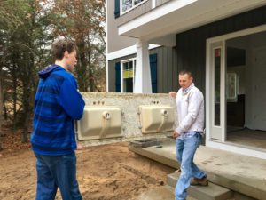 Sable Homes construction superintendent Sean Moody and Jordan Duchon, 17, of Ada carry a granite bathroom countertop into a house under construction in the Sable Valley subdivision in Ada. Duchon is a student at West Michigan Aviation Academy student who observed the construction process as a Sable Homes job shadow participant on Nov. 28, 2016.